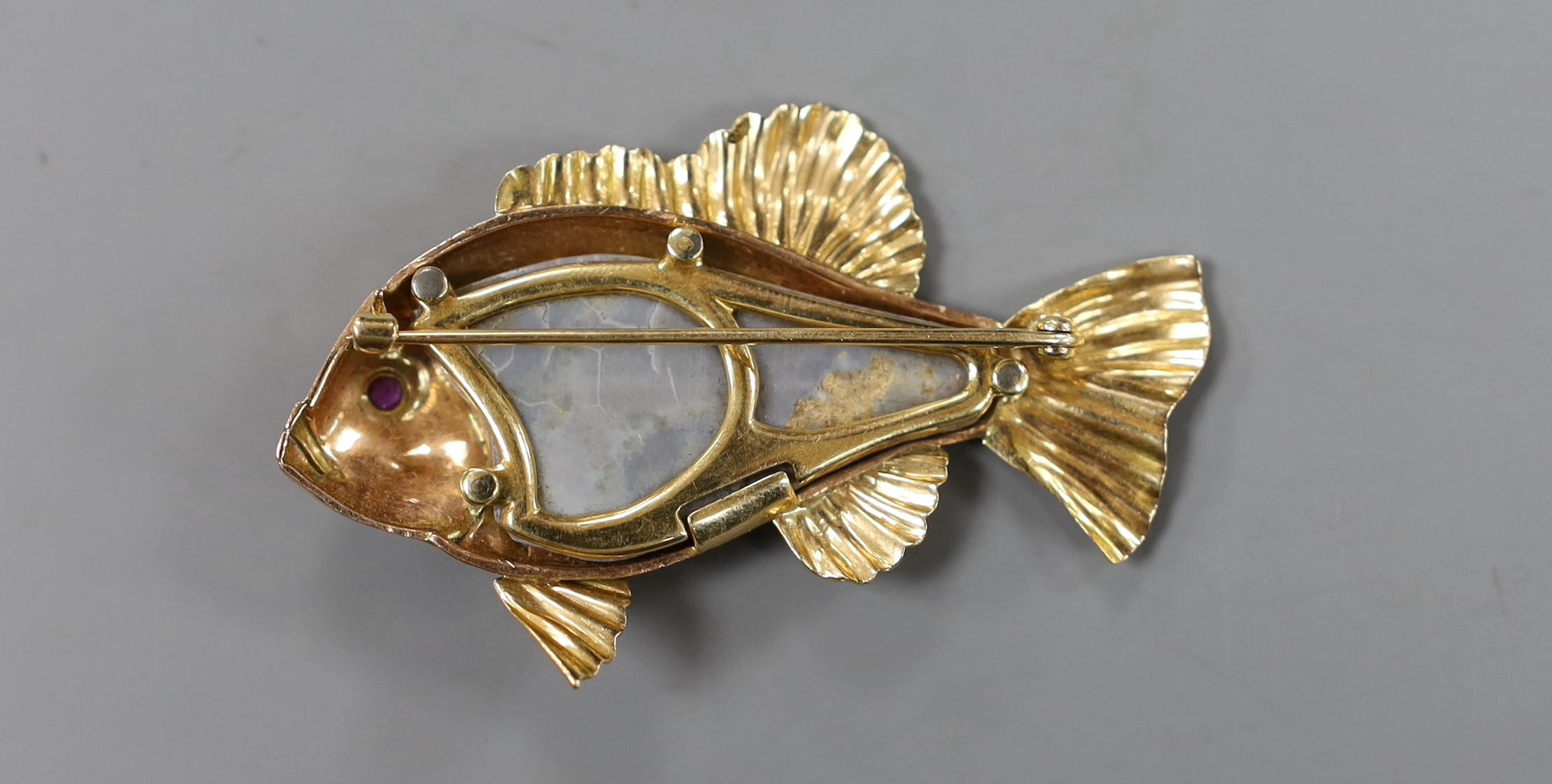 A yellow metal mounted white opal set brooch, modelled as a fish, with cabochon set eye, 60mm, gross weight 16 grams, opal a.f.